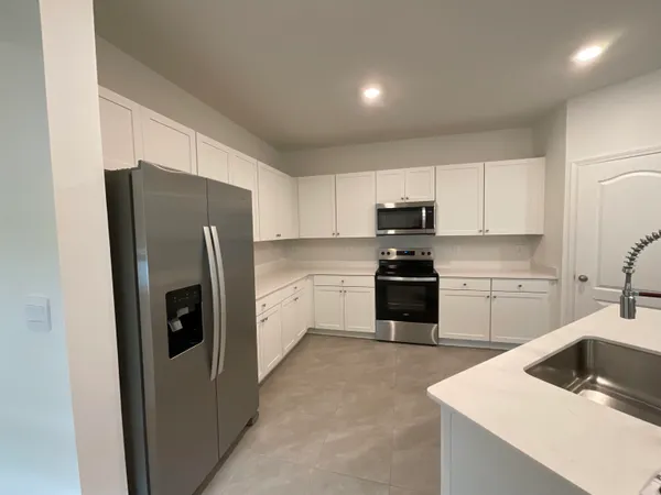 a kitchen with a refrigerator sink and microwave