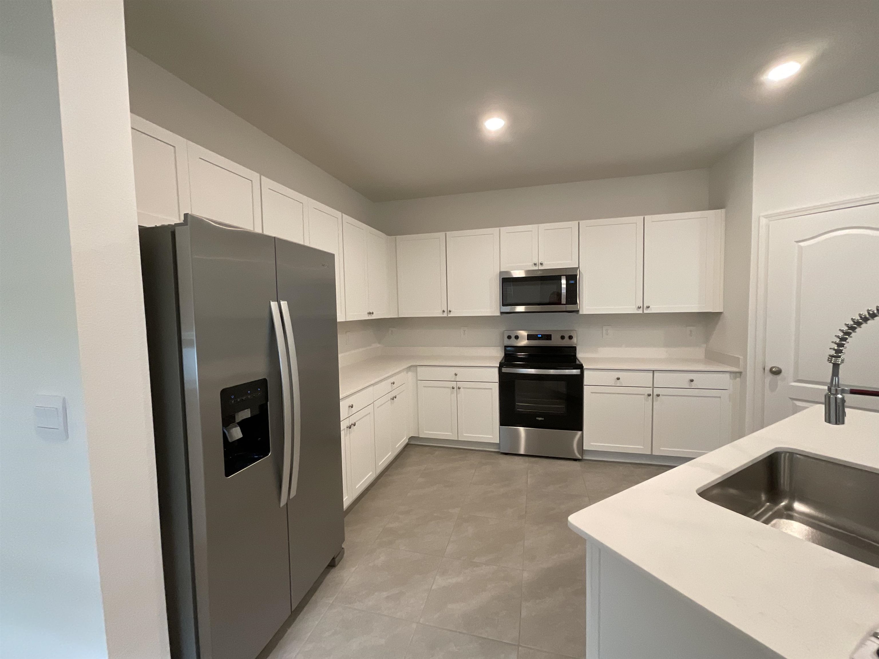 245 Seaport Breeze Road St. Augustine, FL 32095 - Photo 11 of 23 a kitchen with a refrigerator sink and microwave