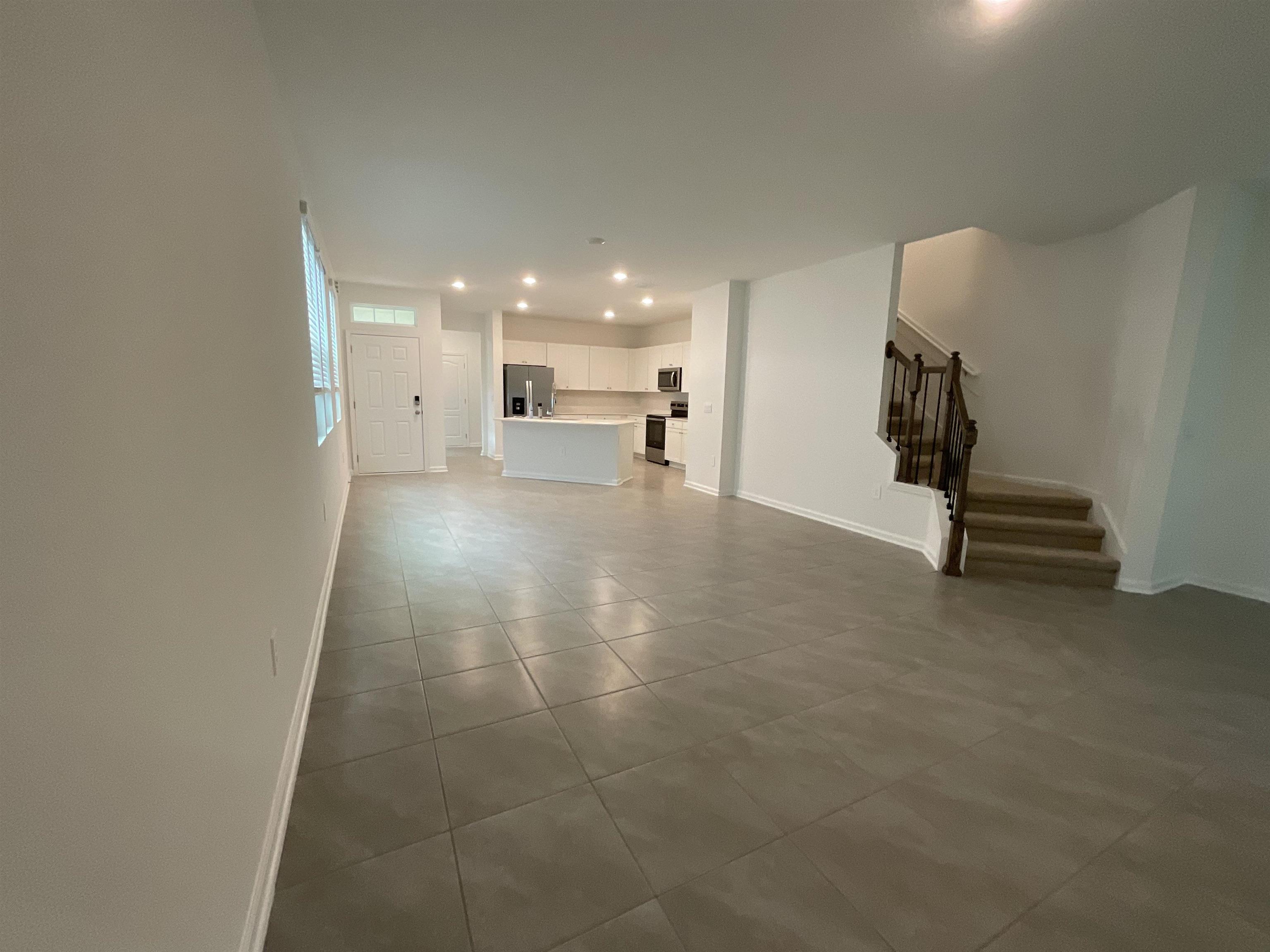 245 Seaport Breeze Road St. Augustine, FL 32095 - Photo 12 of 23 a view of a livingroom with a staircase