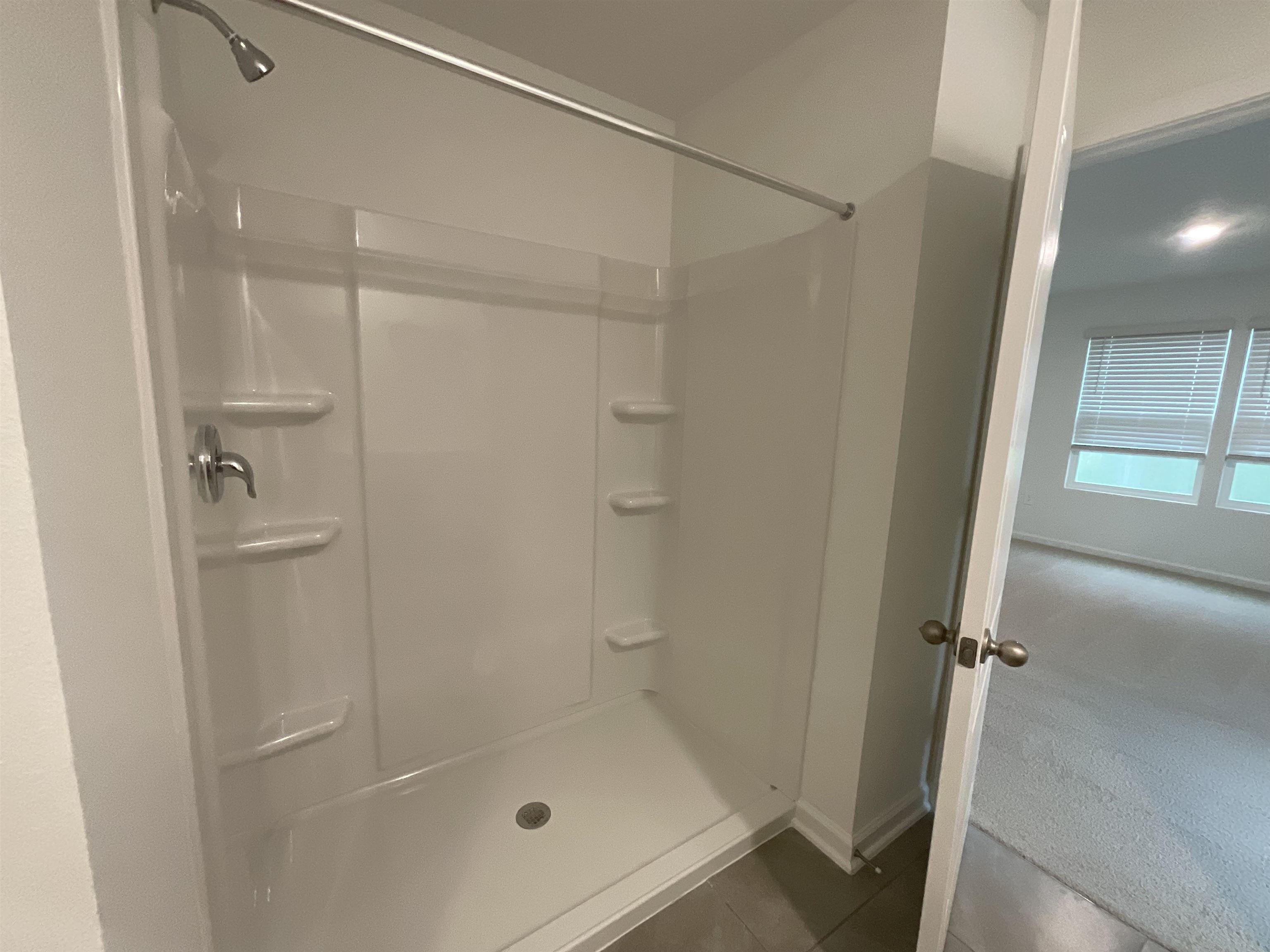 245 Seaport Breeze Road St. Augustine, FL 32095 - Photo 15 of 23 a bathroom with a glass shower door