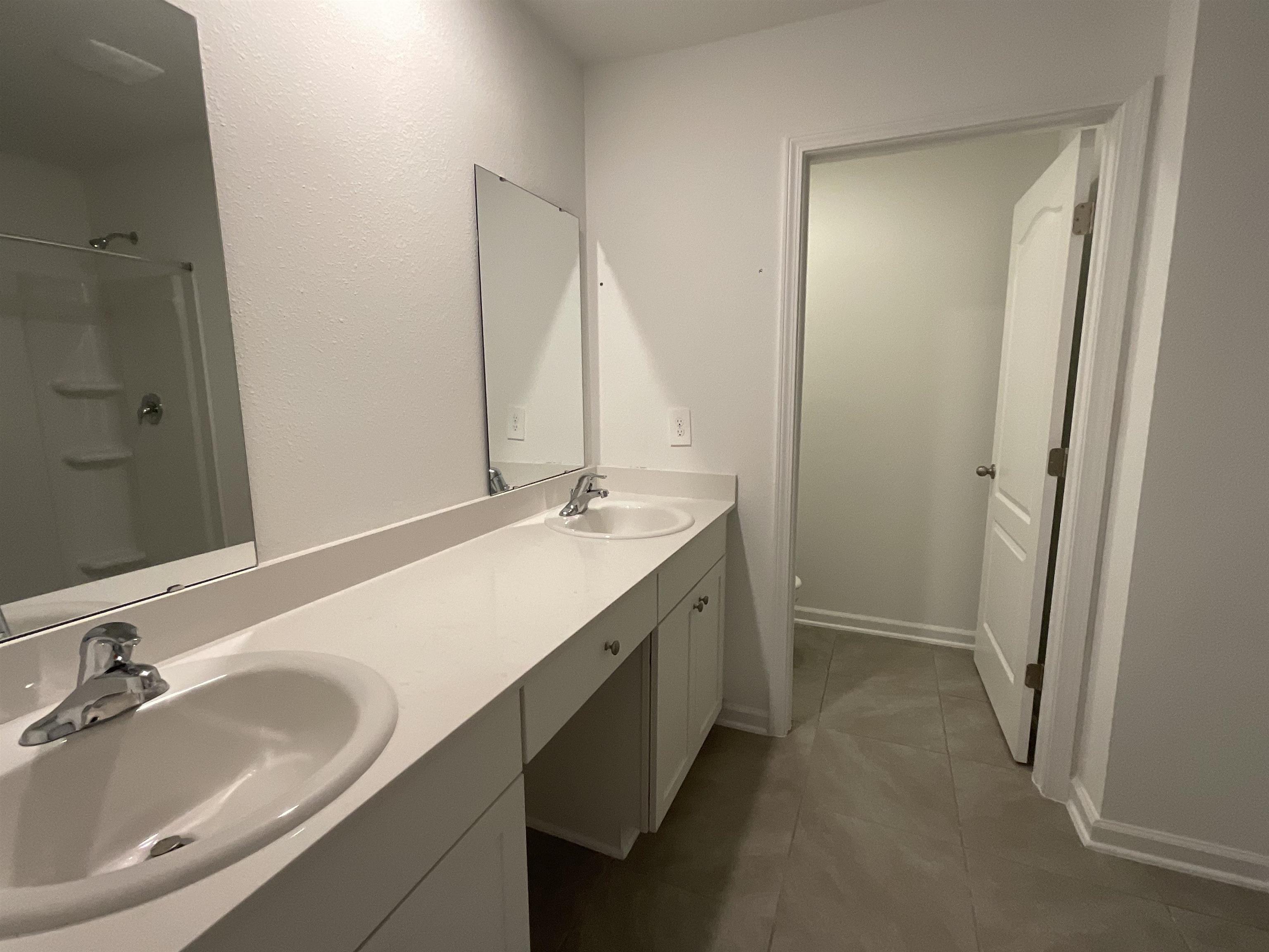 245 Seaport Breeze Road St. Augustine, FL 32095 - Photo 16 of 23 a bathroom with a double vanity sink and a mirror