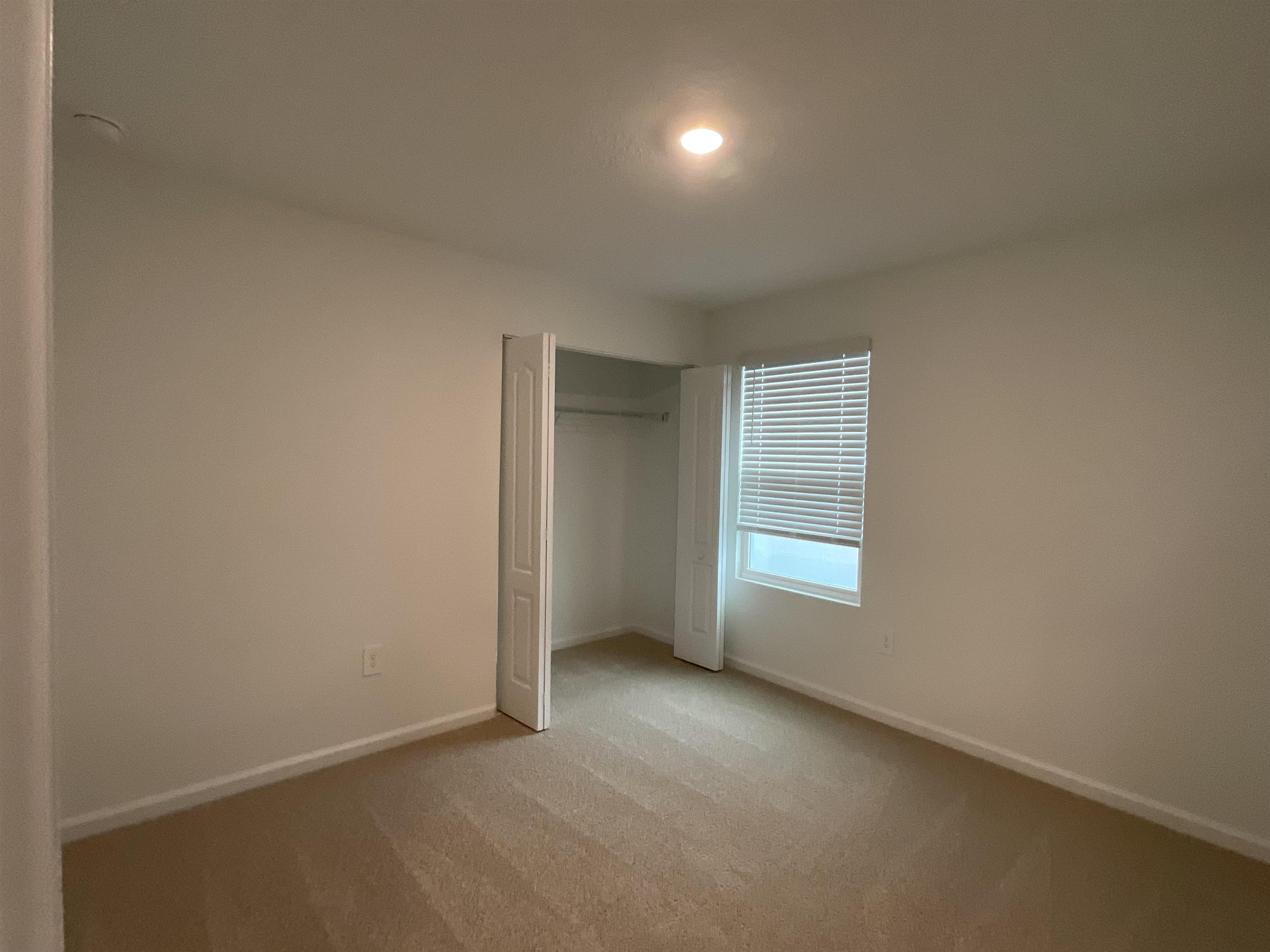 245 Seaport Breeze Road St. Augustine, FL 32095 - Photo 19 of 23 an empty room with closet and windows