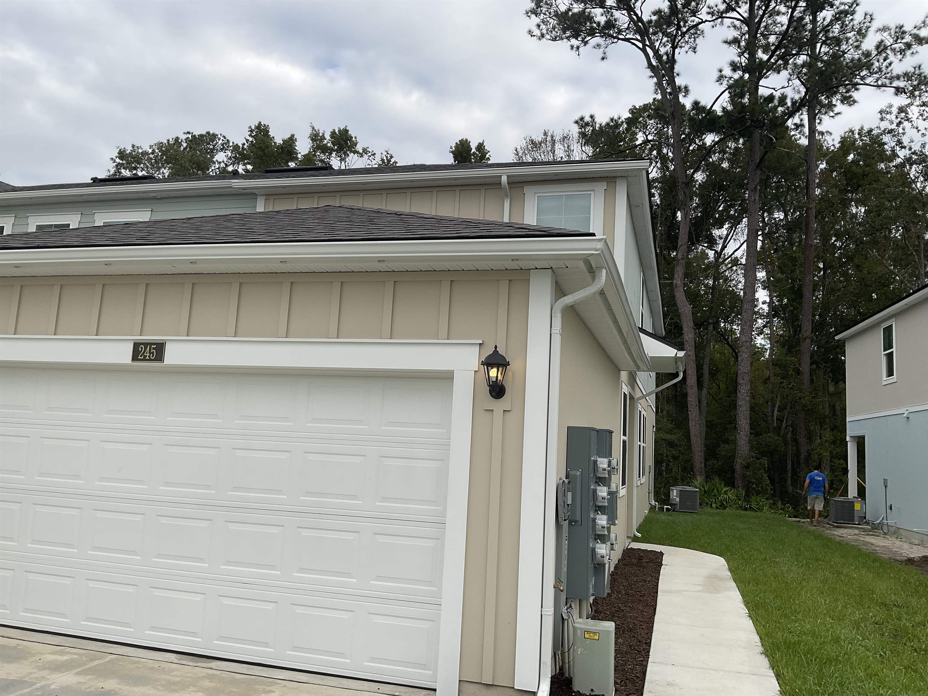245 Seaport Breeze Road St. Augustine, FL 32095 - Photo 2 of 23 a view of a white house with a small yard and a large tree
