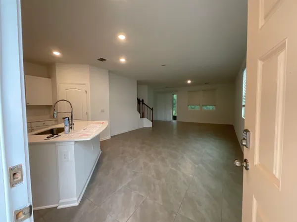 a view of a kitchen with a sink and cabinets