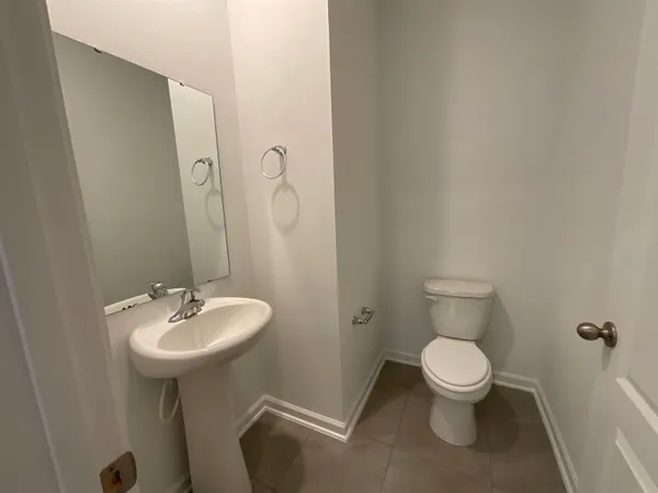 a bathroom with a sink a toilet and mirror