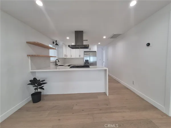 a view of kitchen with stainless steel appliances cabinets and a sink