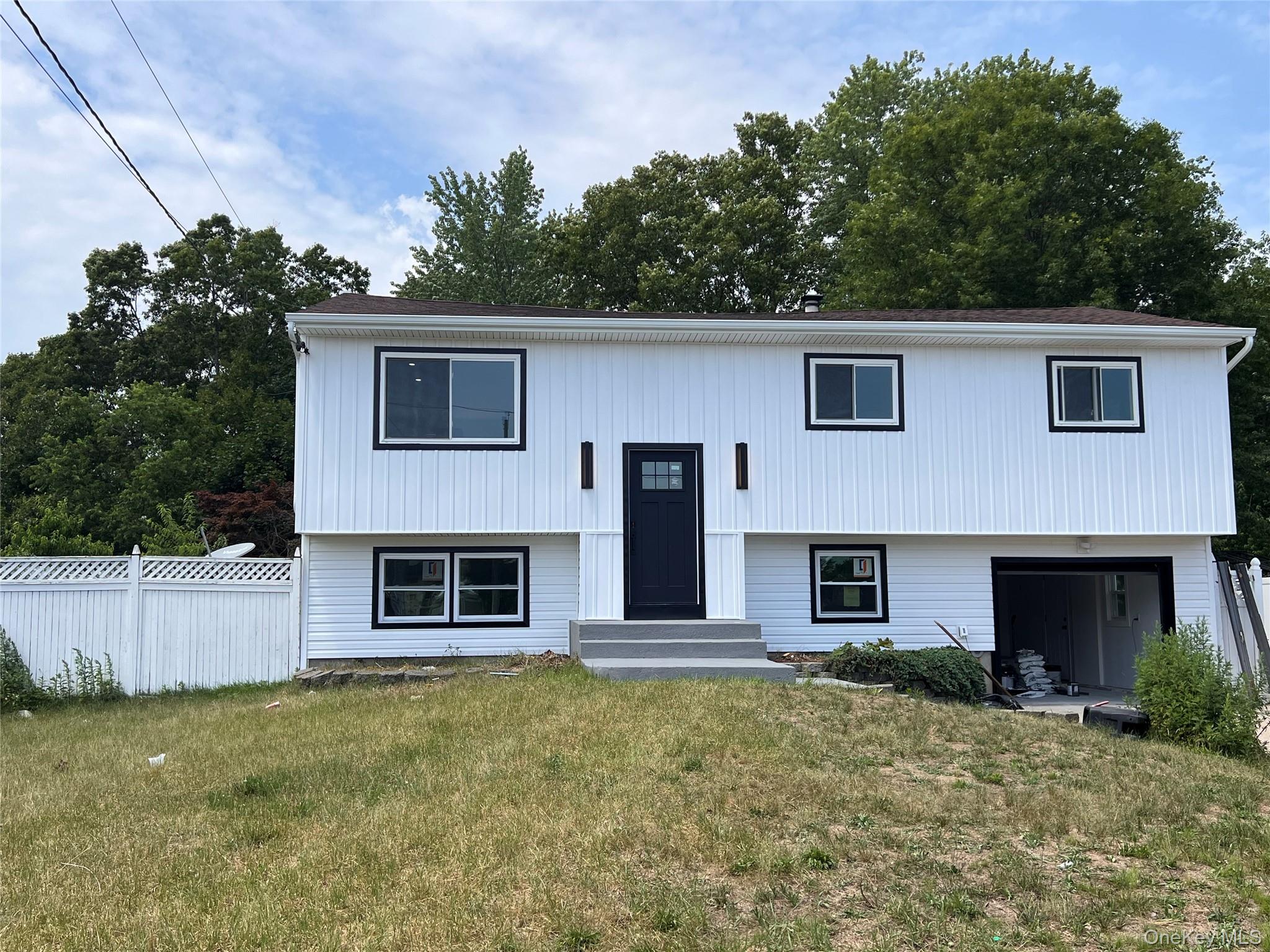 501 Hawkins Road Selden, NY 11784 - Photo 10 of 13 residence featuring white vertical siding with dark trim accents