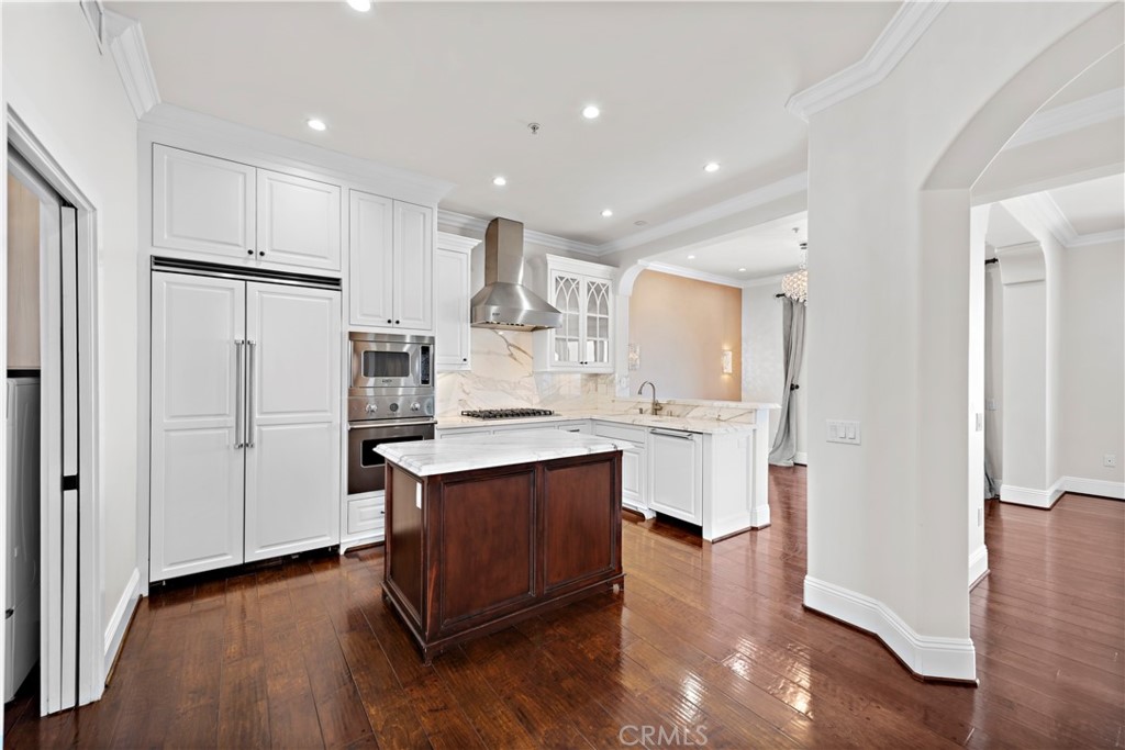25 Splendore Drive Newport Coast, CA 92657 - Photo 2 of 16 a kitchen with white cabinets and stainless steel appliances