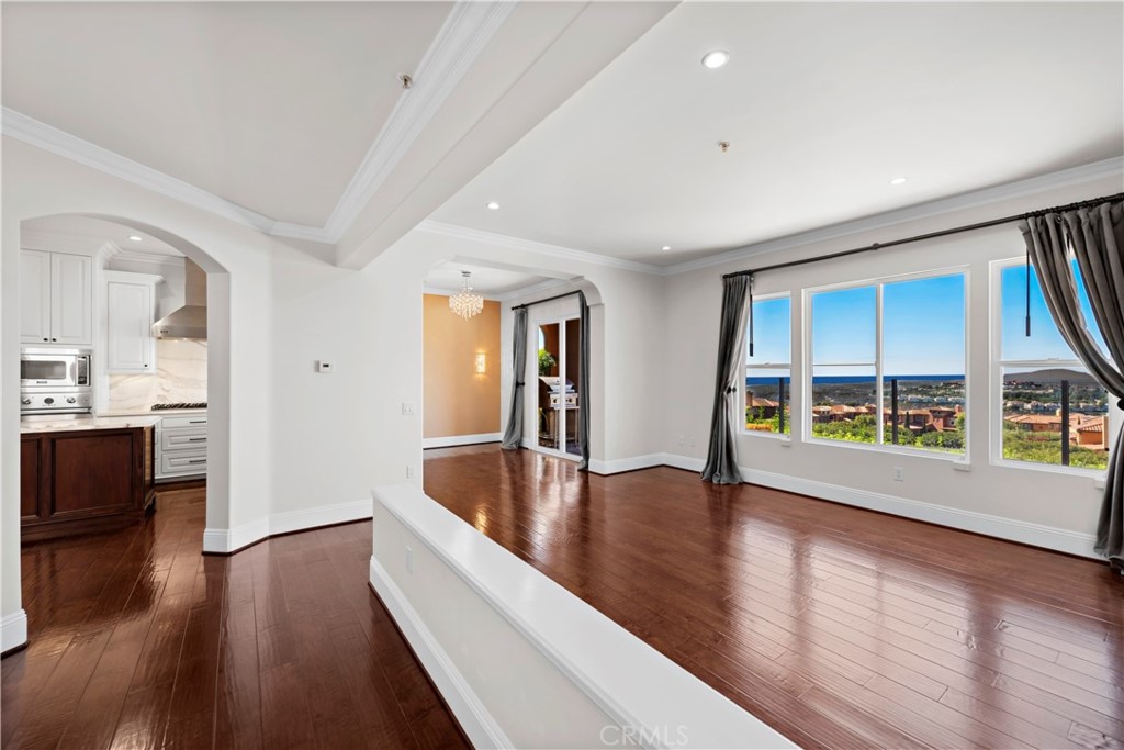 25 Splendore Drive Newport Coast, CA 92657 - Photo 6 of 16 a view of an empty room with wooden floor and a window