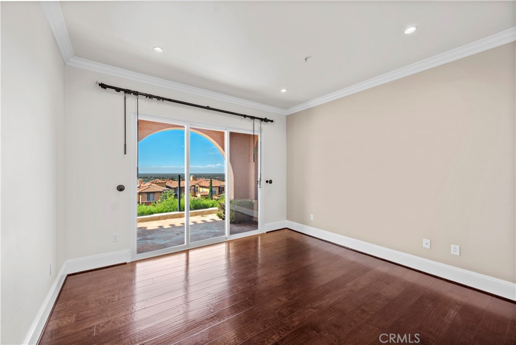 25 Splendore Drive Newport Coast, CA 92657 - Photo 8 of 16 an empty room with wooden floor and a window