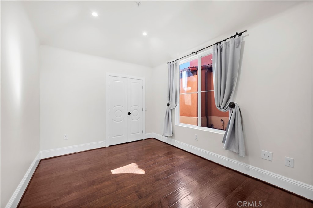 25 Splendore Drive Newport Coast, CA 92657 - Photo 10 of 16 an empty room with wooden floor and windows