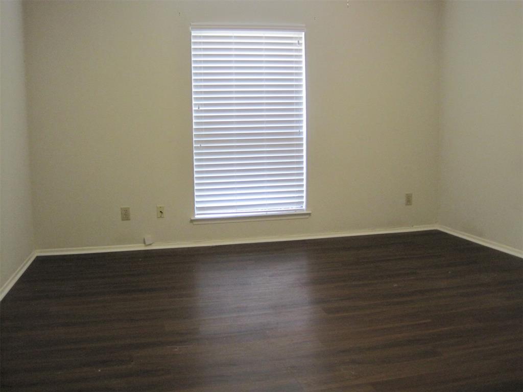 6478 Argo Street Dallas, TX 75214 - Photo 13 of 15 an empty room with wooden floor and a window