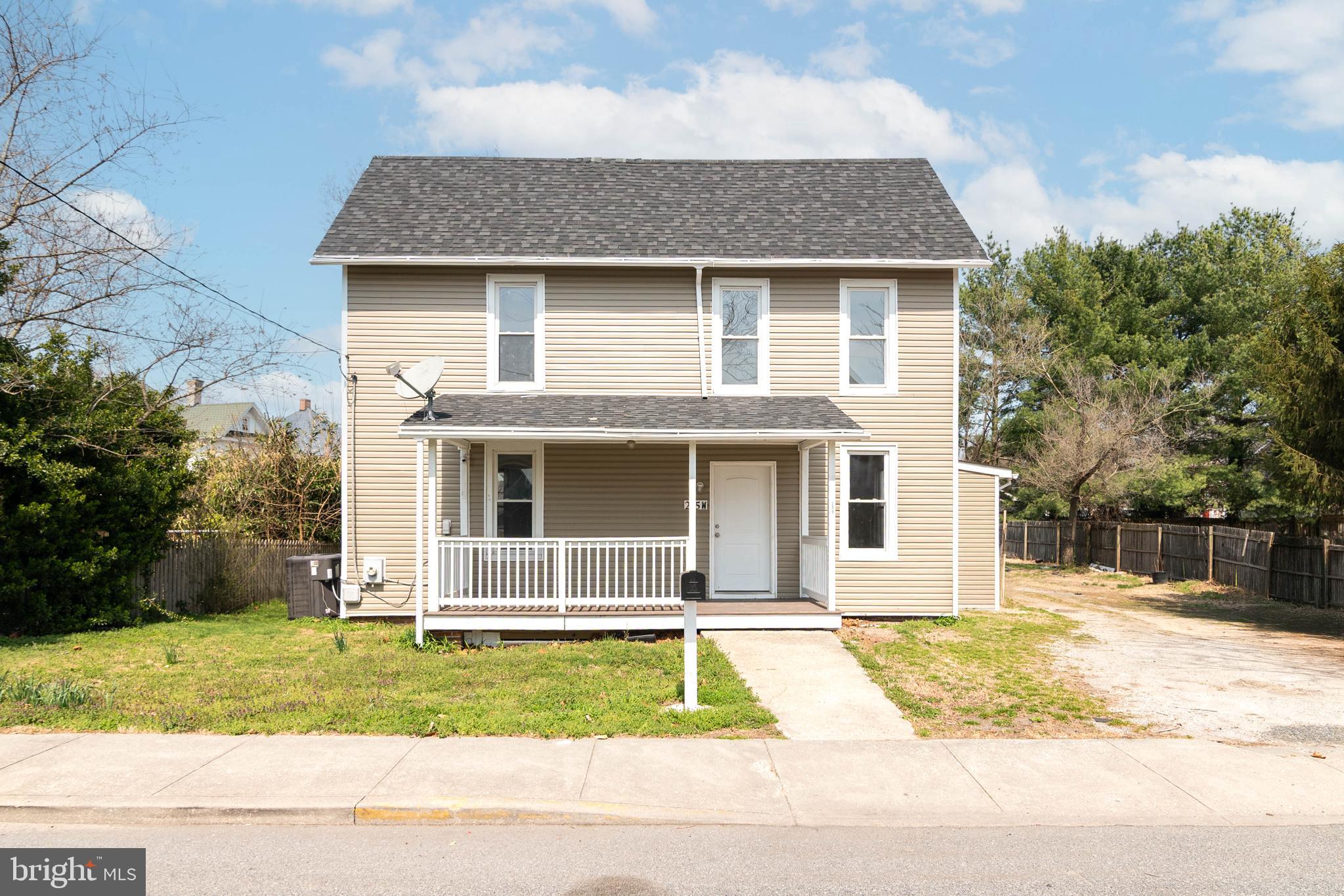 235 West 10th Street Laurel, DE 19956 - Photo 1 of 44 a front view of a house with a garden