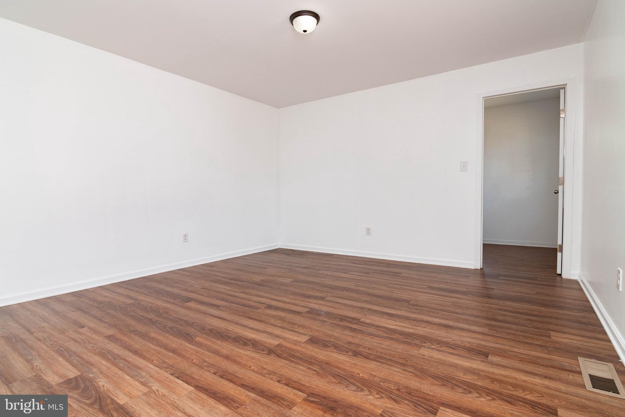 235 West 10th Street Laurel, DE 19956 - Photo 15 of 44 a view of a room with wooden floor and white walls