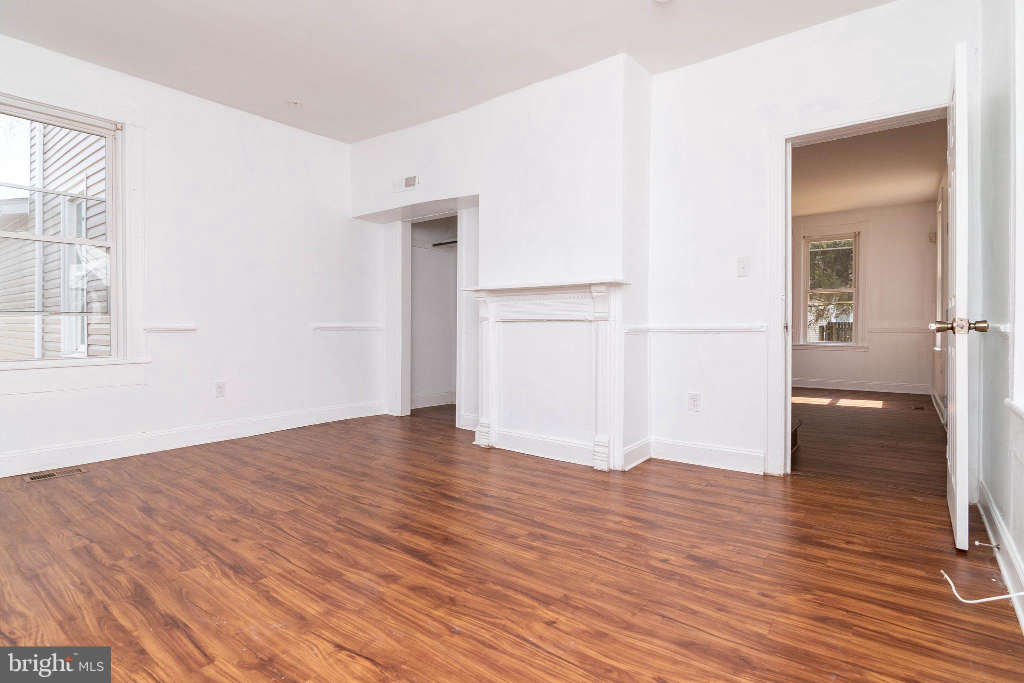 235 West 10th Street Laurel, DE 19956 - Photo 18 of 44 an empty room with wooden floor and windows