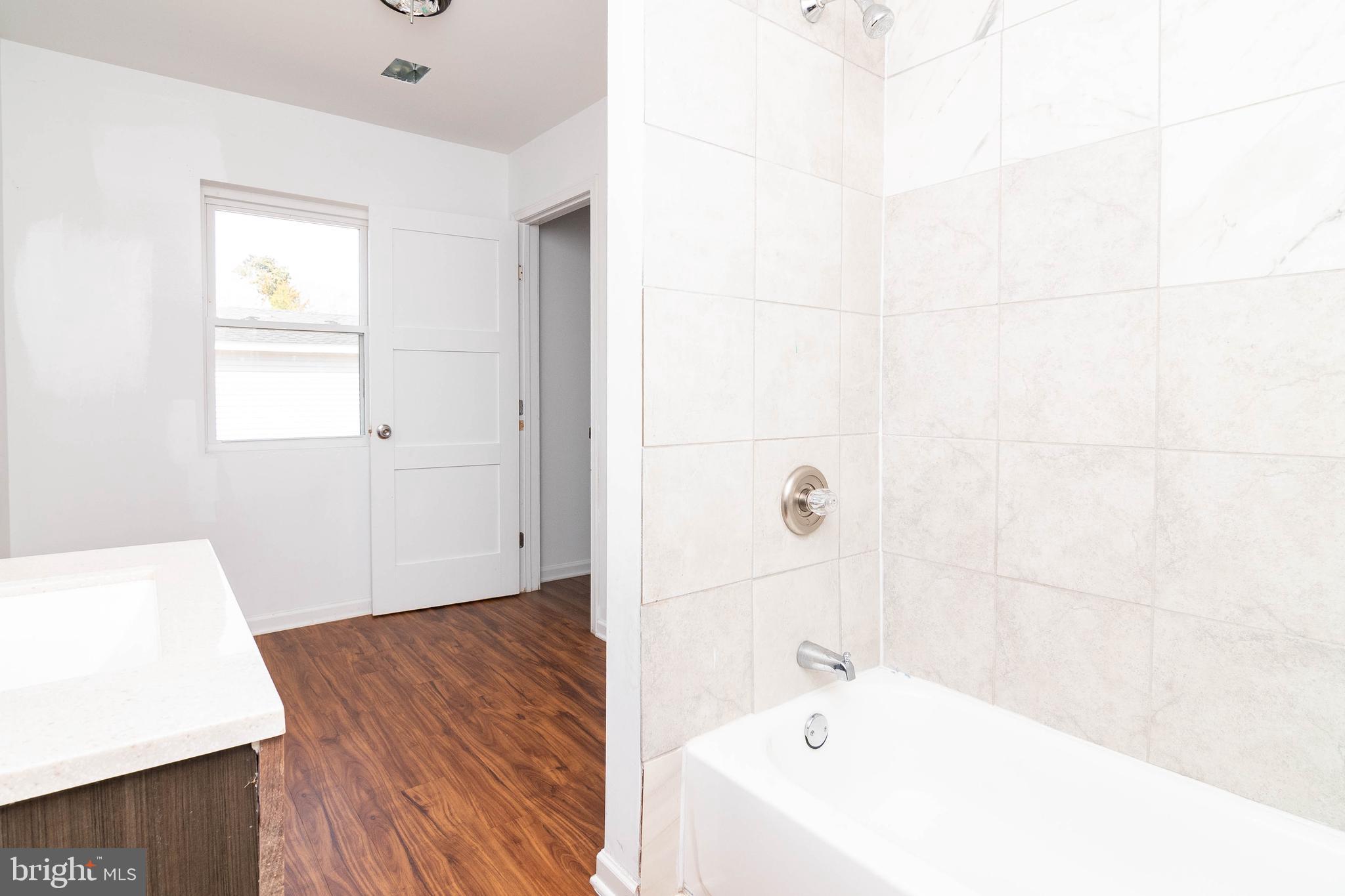 235 West 10th Street Laurel, DE 19956 - Photo 29 of 44 a bathroom with a bathtub and a window