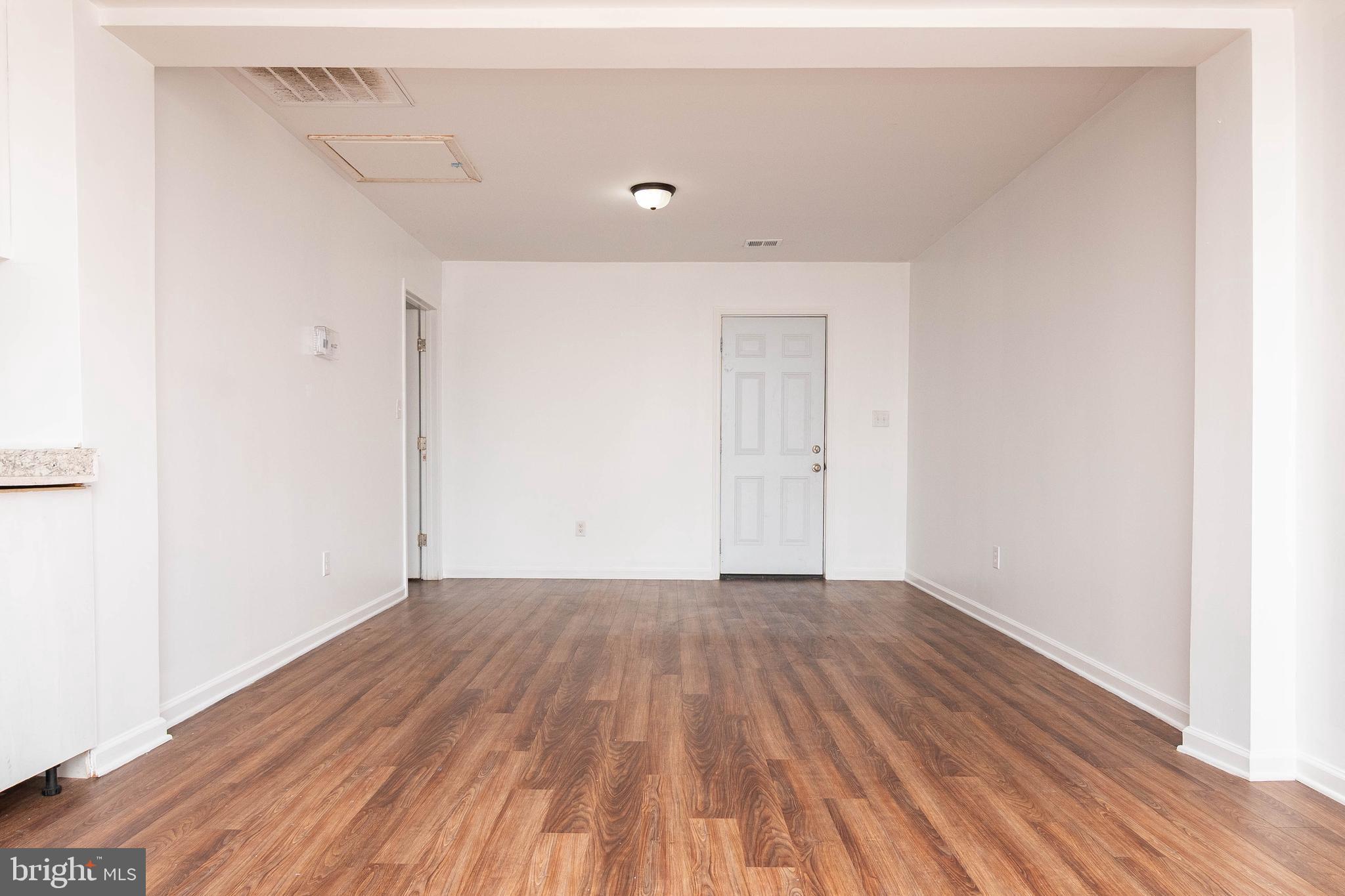 235 West 10th Street Laurel, DE 19956 - Photo 6 of 44 a view of a room with wooden floor
