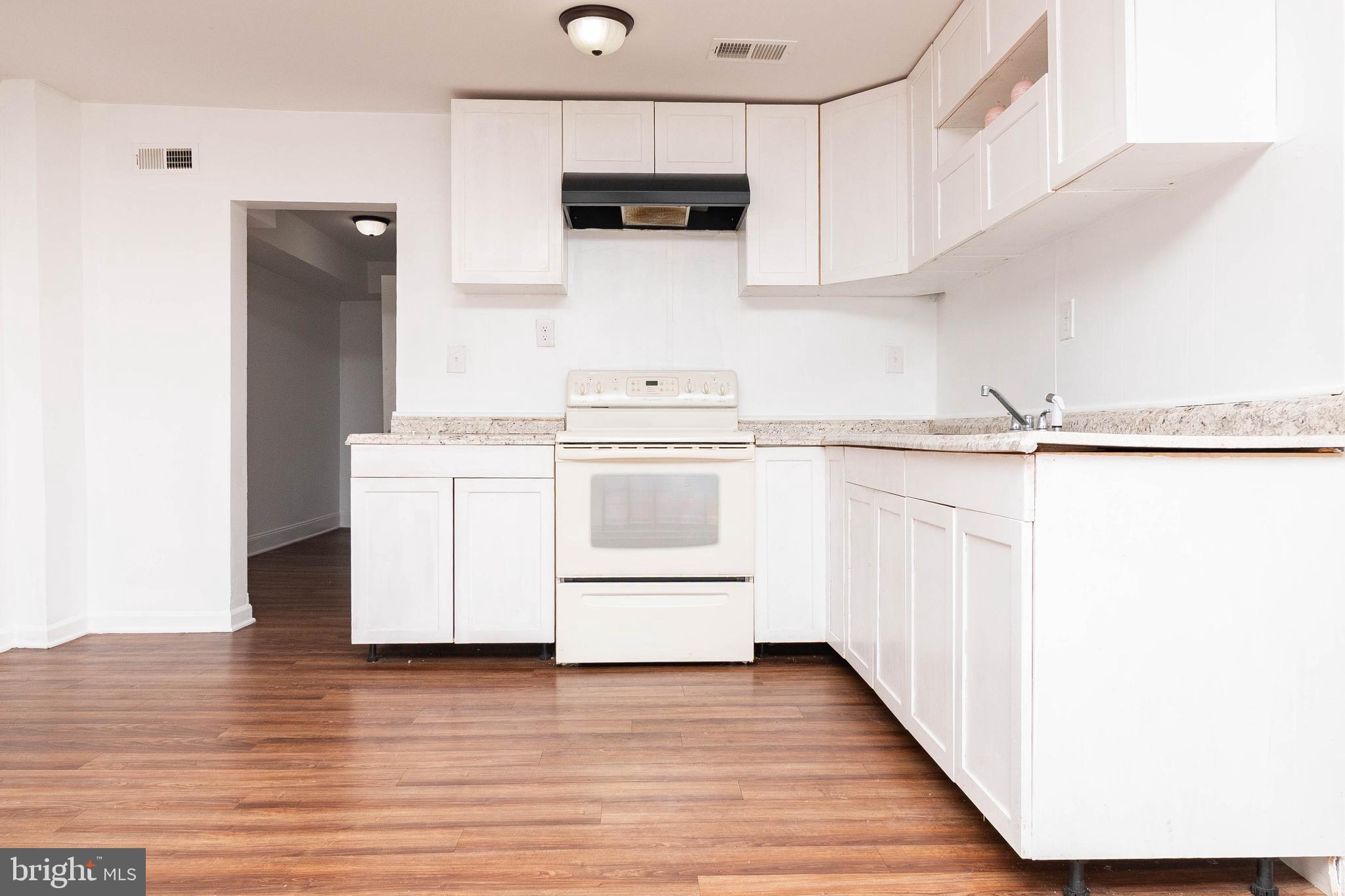235 West 10th Street Laurel, DE 19956 - Photo 8 of 44 a kitchen with stainless steel appliances a white stove top oven and sink