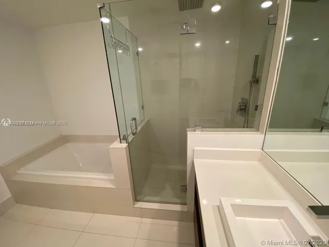 a bathroom with a bathtub and a shower