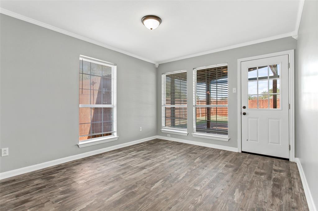 712 Billups Street Van Alstyne, TX 75495 - Photo 11 of 38 an empty room with wooden floor and windows