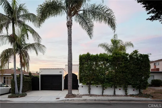 a front view of a house with yard and parking