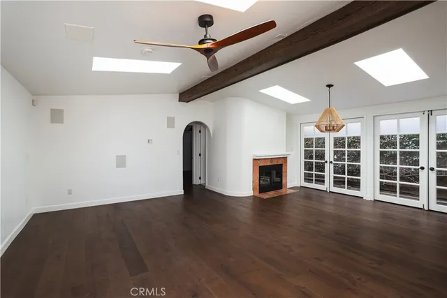 wooden floor in an empty room with a fireplace