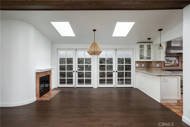 a kitchen with granite countertop a stove sink and cabinets