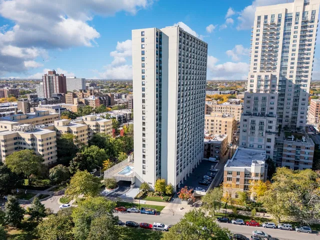 a spacious bedroom with a large bed and a large window