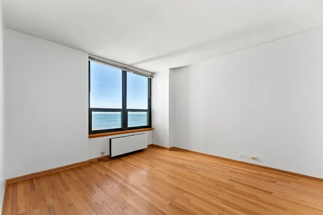 a view of an empty room and wooden floor