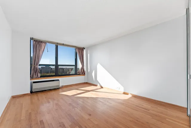 a view of a room with wooden floor and staircase