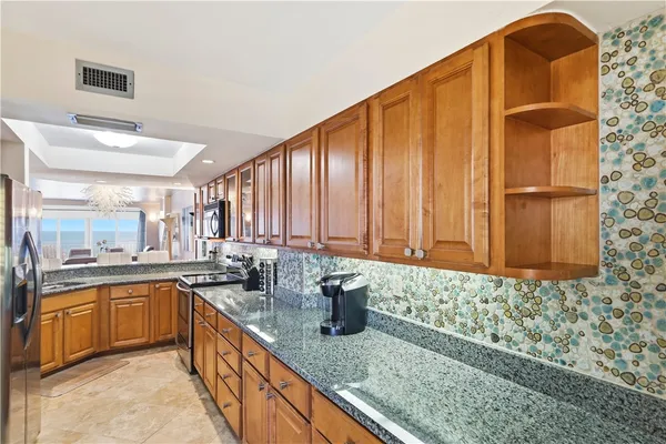 a kitchen with a granite countertop sink and a granite counter tops