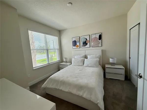 a bedroom with a bed and a window