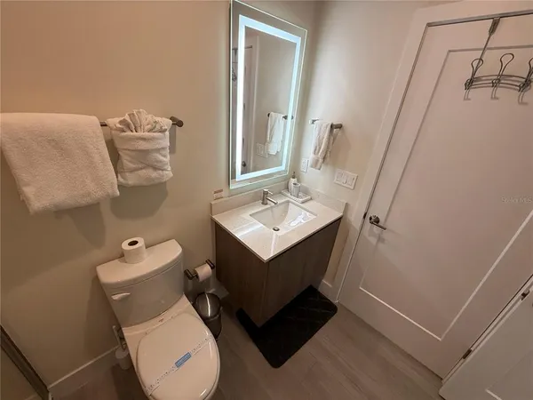 a bathroom with a toilet sink and mirror
