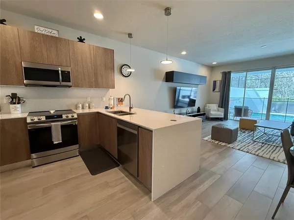 a kitchen with a sink a counter top space cabinets stainless steel appliances and a window