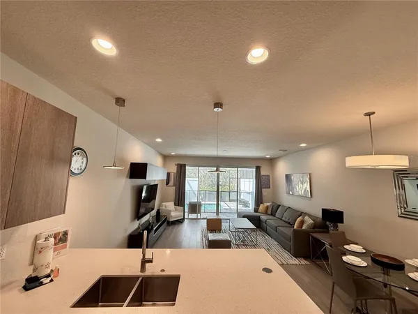 a living room with furniture a large window and a flat screen tv