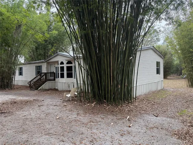 a view of house with backyard and garden