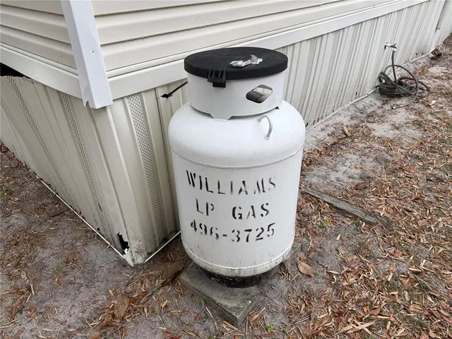 a view of a house with a yard and tree