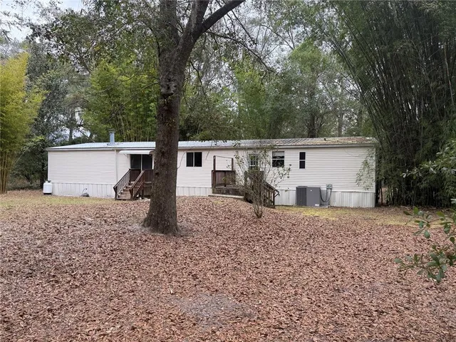 a large kitchen with stainless steel appliances granite countertop a large counter top a stove and a sink