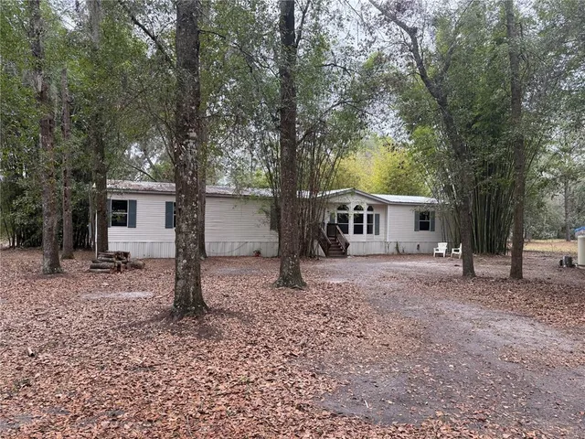 a large kitchen with stainless steel appliances kitchen island granite countertop a refrigerator and a stove top oven