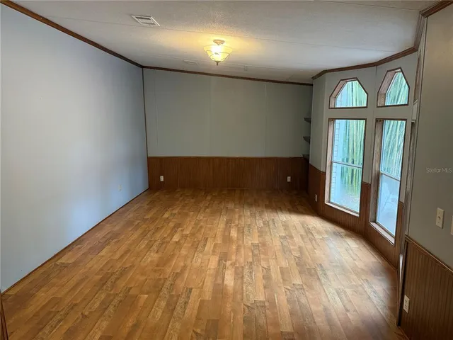 a spacious bedroom with a bed and a dresser