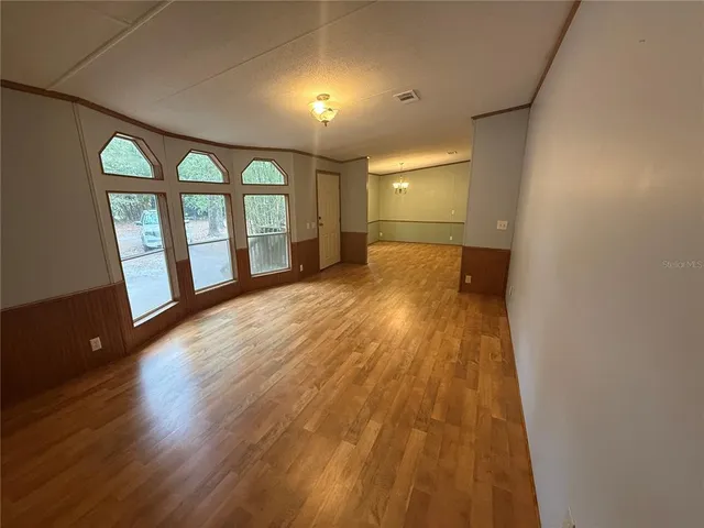 a bathroom with a toilet mirror vanity and sink