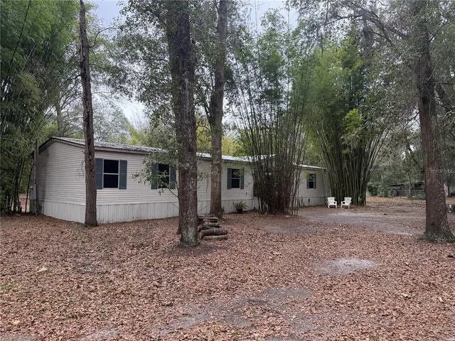 a backyard of a house with lots of green space