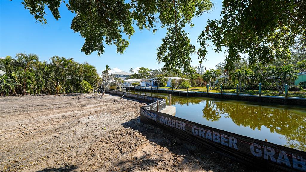 a view of a lake with boats and trees in the background