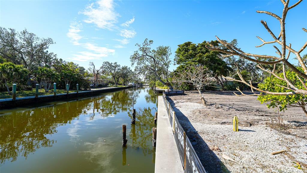 660 Longview Drive Longboat Key, FL 34228 - Photo 7 of 35 a view of a lake with a palm tree
