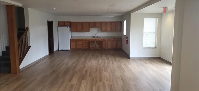 a kitchen with stainless steel appliances a refrigerator and a stove top oven