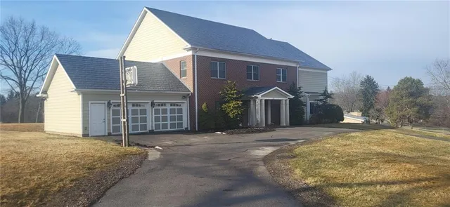 a view of a house with a yard and garage