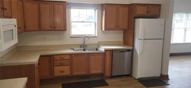 a kitchen with stainless steel appliances granite countertop a refrigerator sink and cabinets