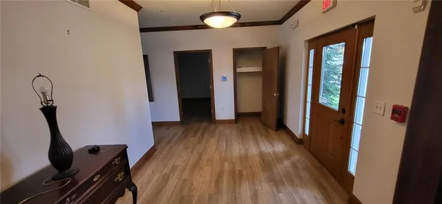 a view of a room with wooden floor