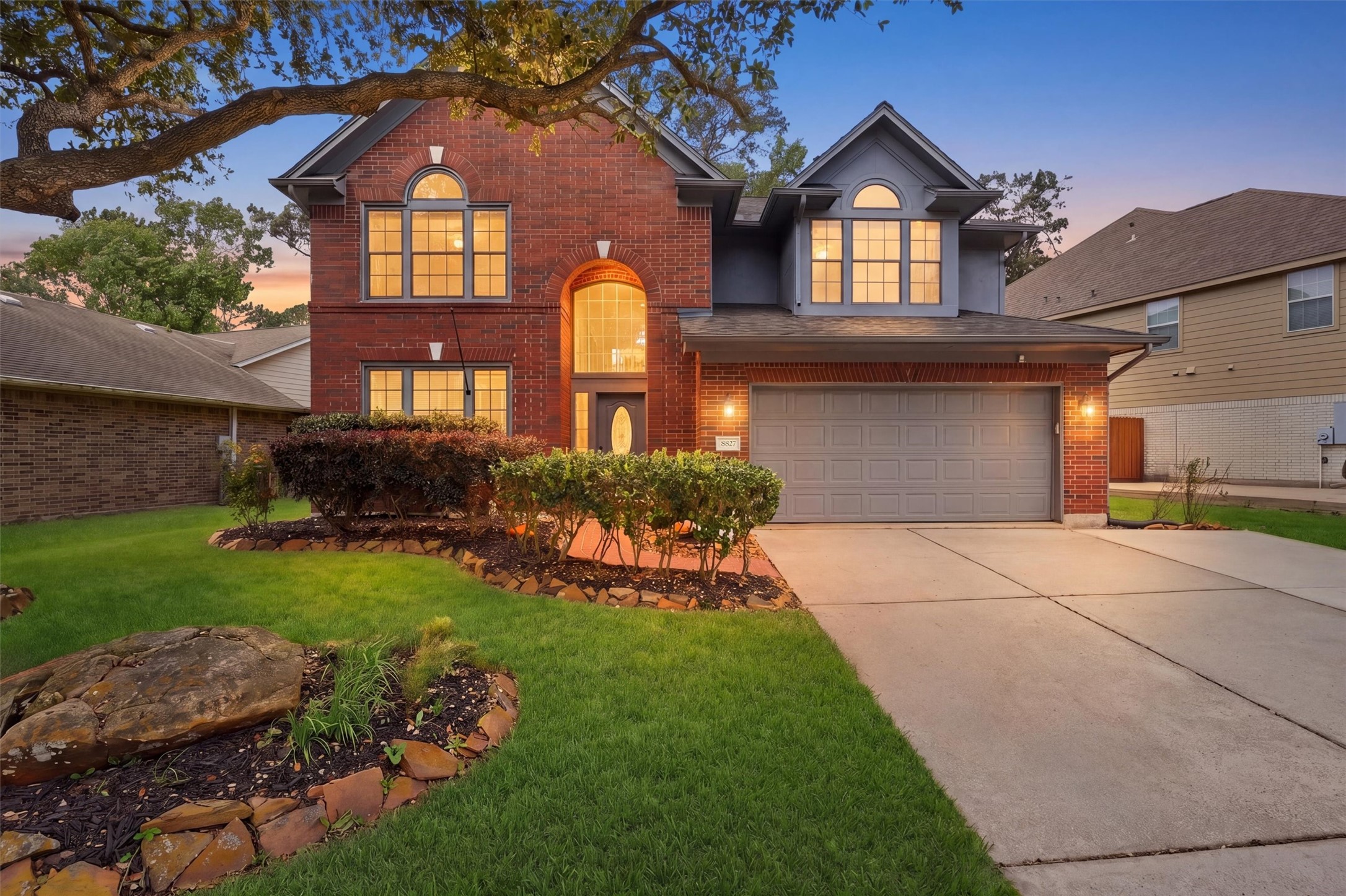 8827 Mile Run Road Humble, TX 77346 - Photo 2 of 37 a front view of a house with a yard and garage