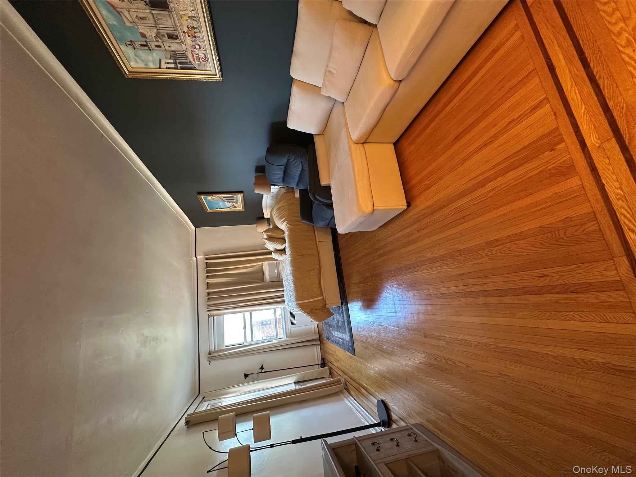 86-10 34th Avenue, Unit 624 Queens, NY 11372 - Photo 4 of 20 Living area featuring light wood-style flooring and crown molding